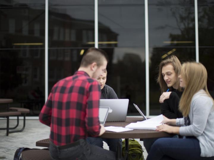 students at table outside